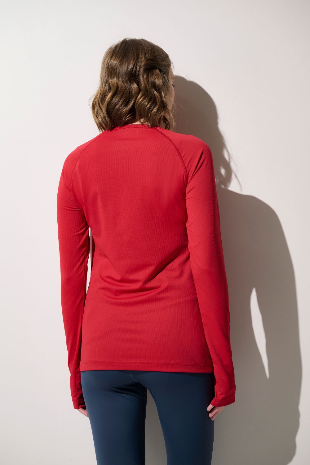 T-shirt anti-UV rouge pour femme, léger et respirant, offrant une protection solaire UPF 50+ pour les activités extérieures.
