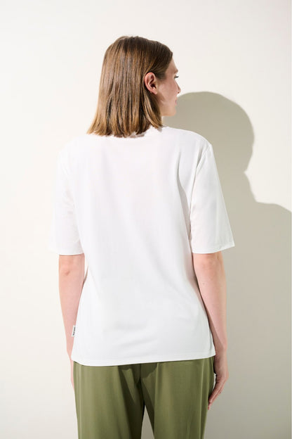 T-shirt anti-UV blanc UPF 50+ pour femme, léger et élégant, idéal pour les journées ensoleillées.