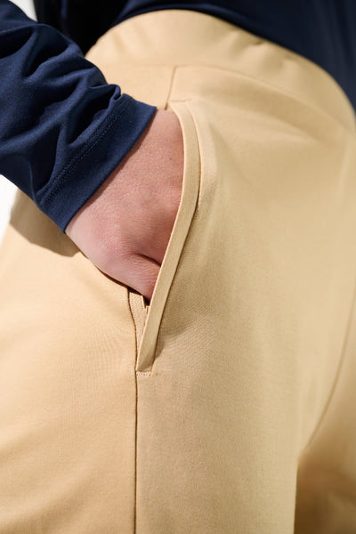 Pantalon anti-UV beige pour femme, léger et élégant, offrant une protection solaire UPF 50+ avec poches pratiques.